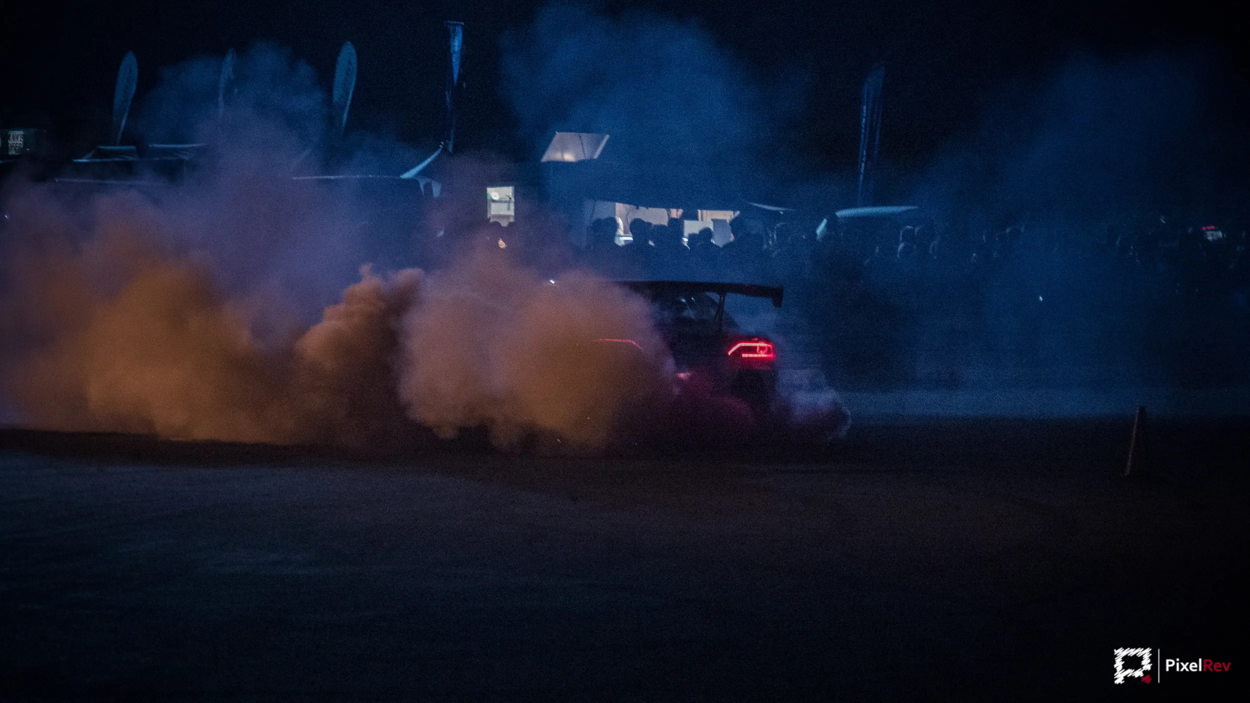 Driftfahrzeug von Robby Rock Racing in Reifenqualm bei Nacht