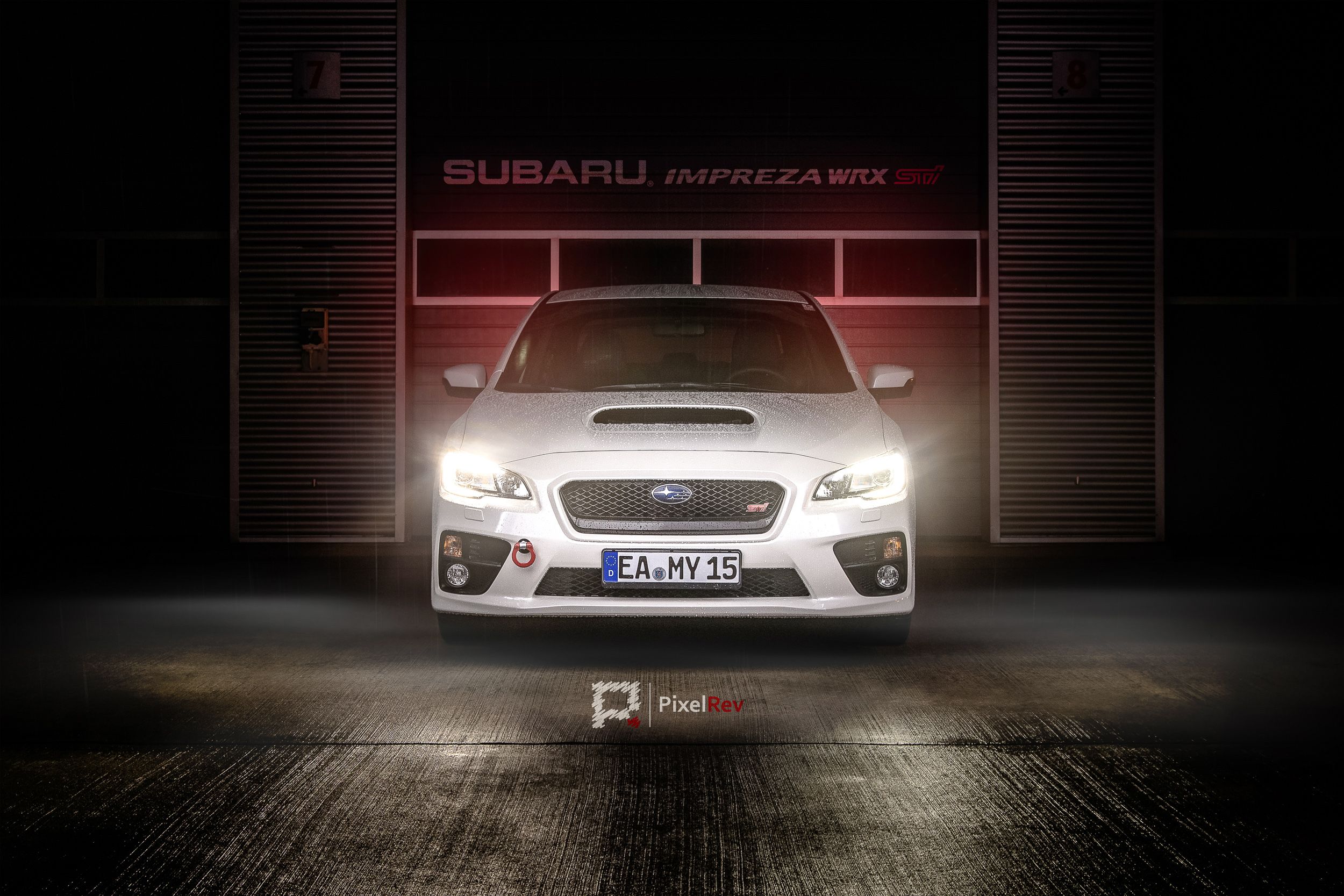 Weißer Subaru WRX STI mit eingeschalteten Scheinwerfern vor der dunklen Box